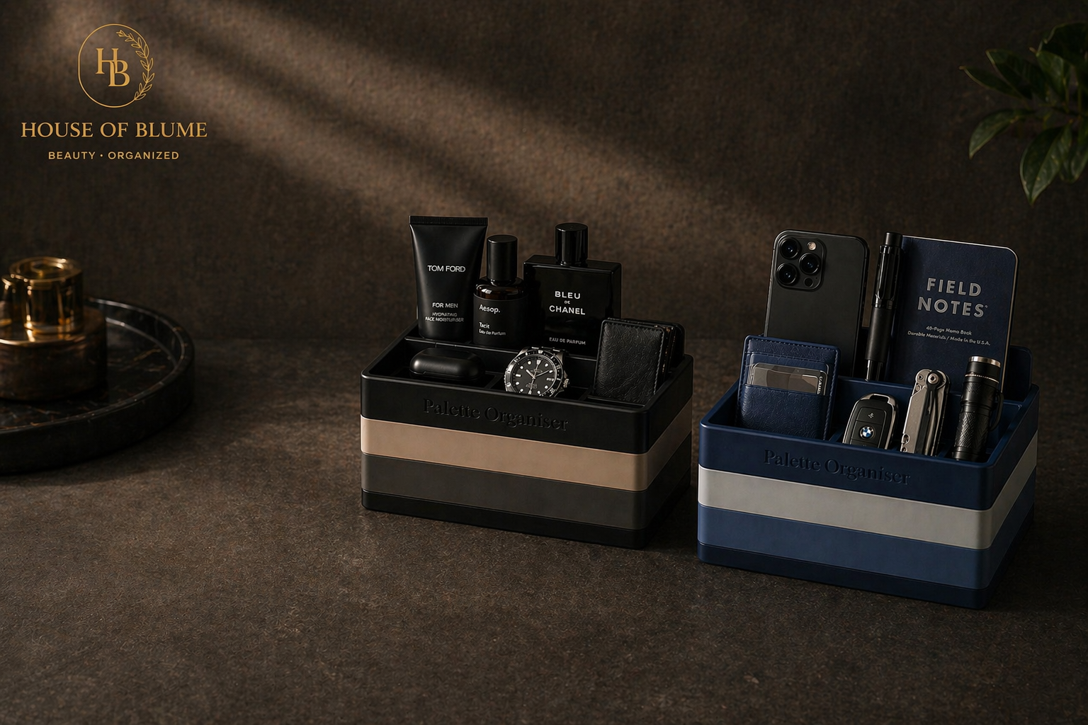 Two ClikBrik organisers - black/tan Noir and navy/cream Harbour - styled with grooming products and everyday carry on a moody dark textured surface